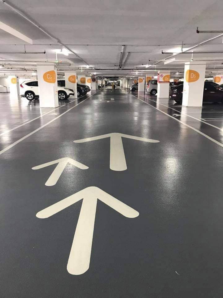 Grey car-park ramp with directional arrows: epoxy deck, grey + arrows
