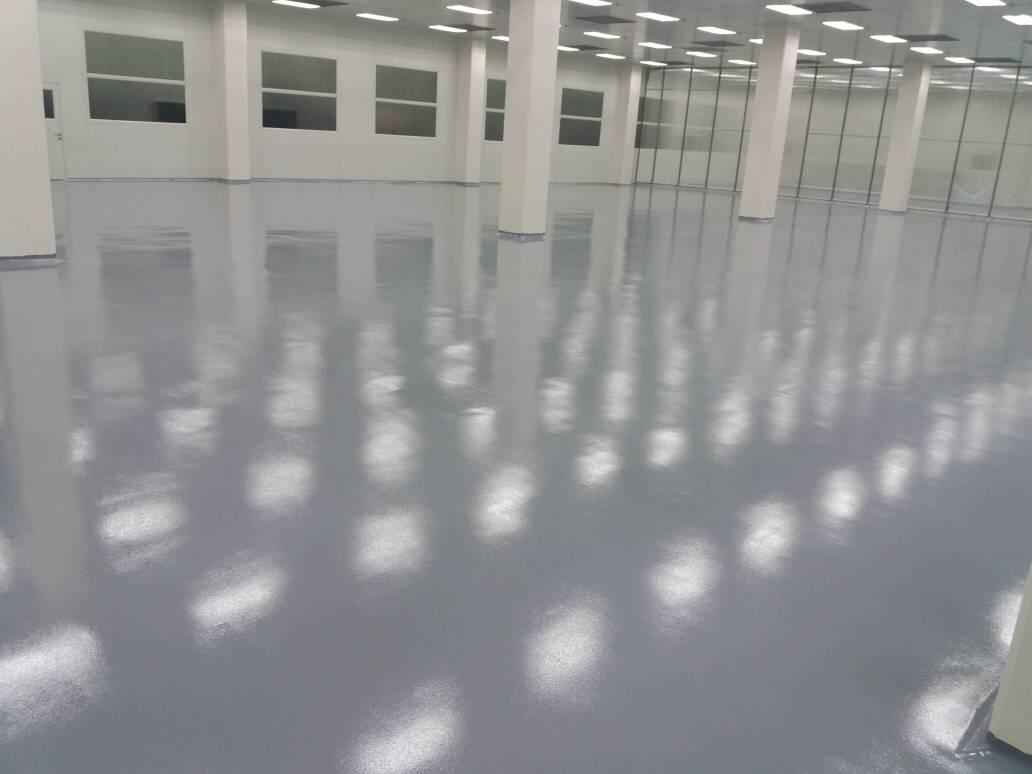 Flowrock Systems team installing a high-gloss seamless resin floor